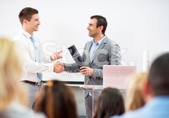 stock-photo-72608835-businessman-shaking-hands-with-professor-and-receiving-a-diploma-